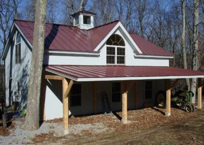 White barn with red metal roof