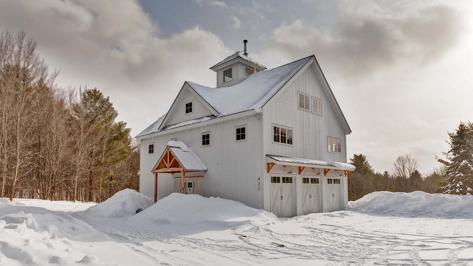 Exterior view of The Great White Barn in a fresh blanket of snow.