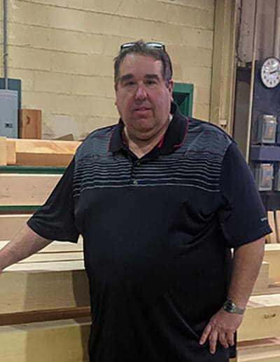 Man standing in front of timbers