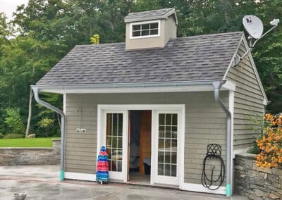 Small pool cabana with cupola and satellite dish.