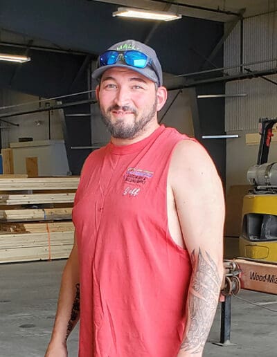 Man standing in workshop on River Road.